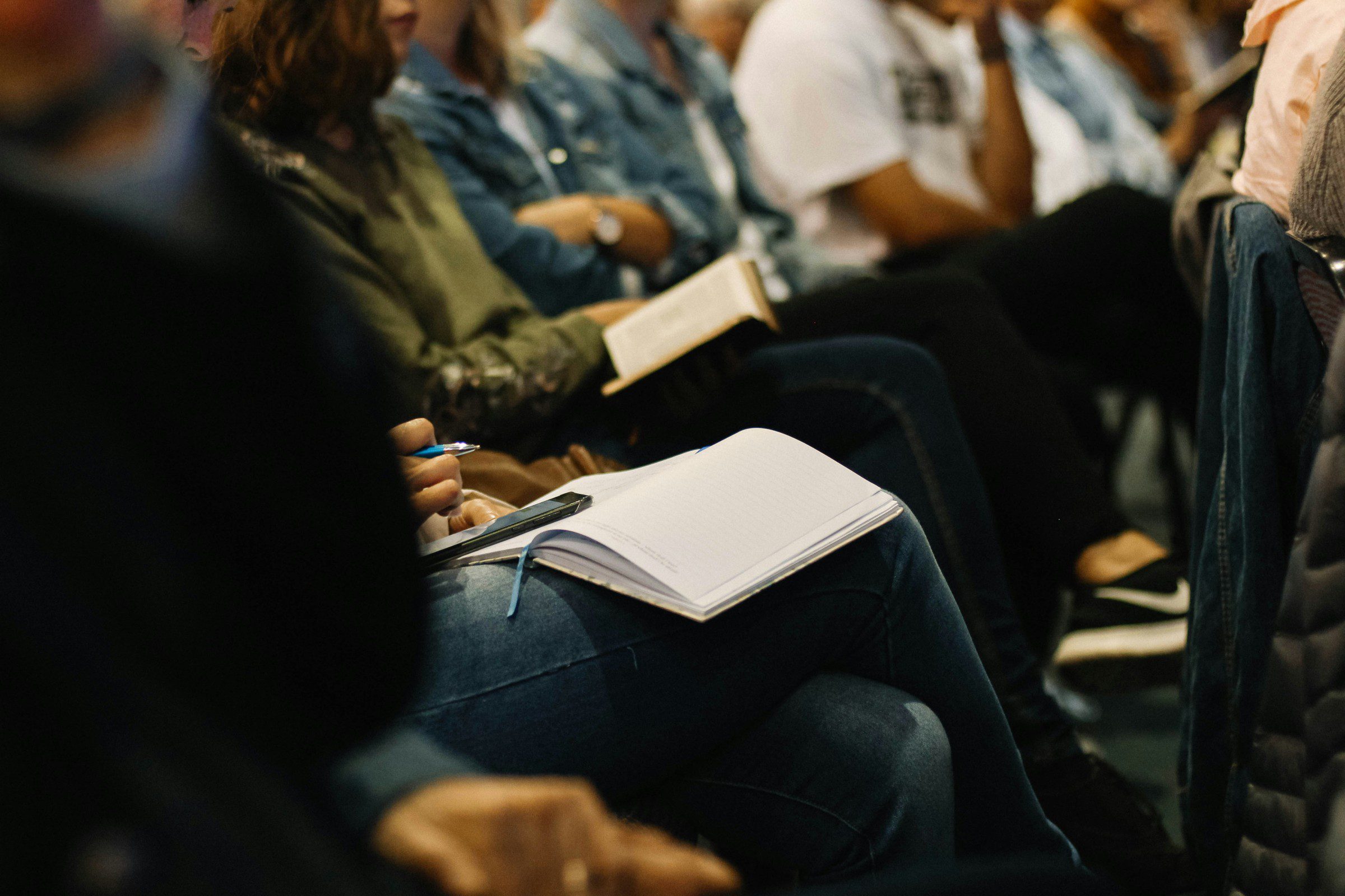 People taking notes at a meeting
