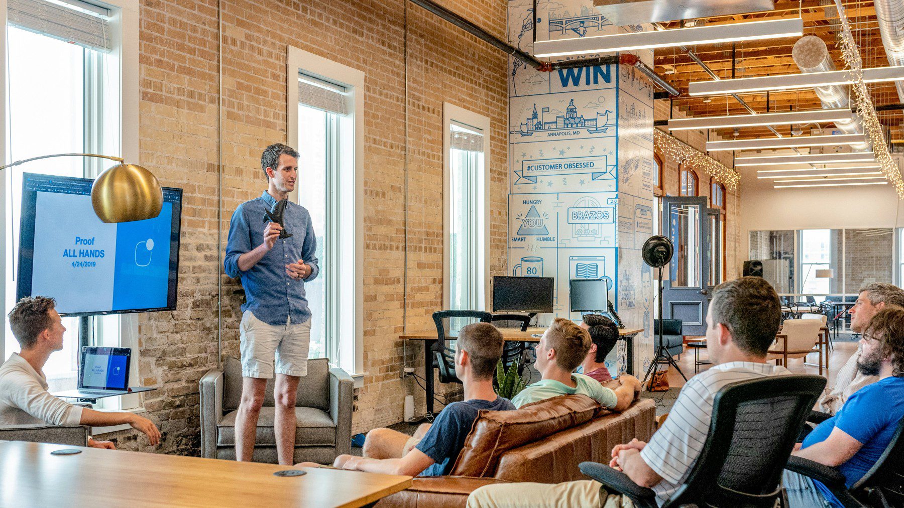 A person with a mike in front of a small audience